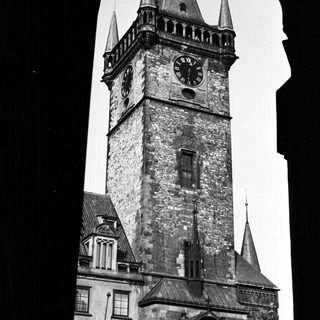 Black and white photo of a tall, historic clock tower.