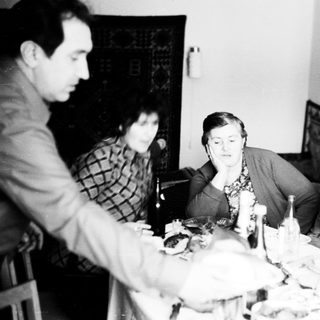 Group seated around a table, likely during a meal.