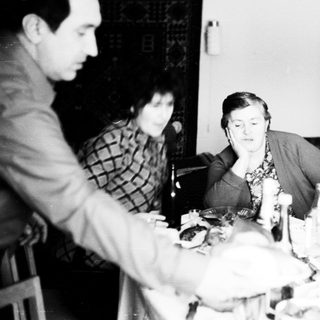 Group seated around a table, likely during a meal.
