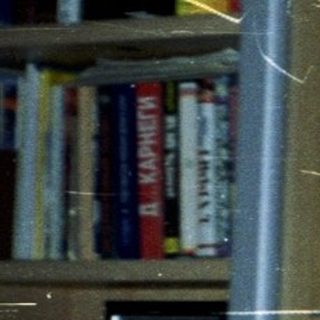 Here's a brief summary of the image: Woman holding baby in a room with shelves.