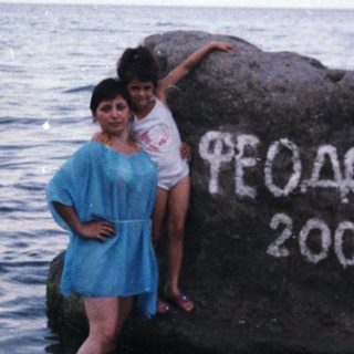Woman and child on rock in shallow water, 2006.