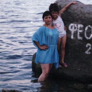 Woman and child on rock in shallow water, 2006.