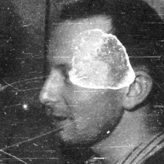 Here's a brief summary of the image: A smiling woman and a man in profile are pictured.