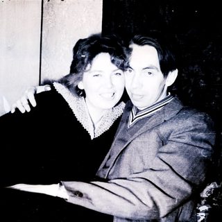 Couple posing for a black and white portrait.