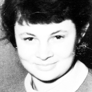 Black and white photo of a young woman smiling.