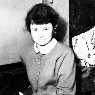 Black and white photo of a young woman smiling.
