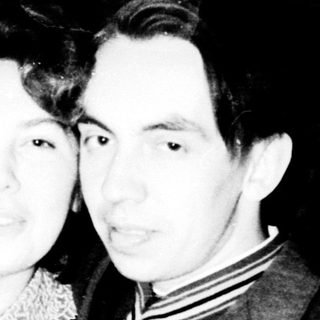 Black and white photo of a couple standing together.
