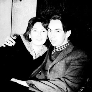 Black and white photo of a couple standing together.