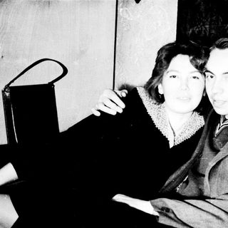 Black and white photo of a couple standing together.