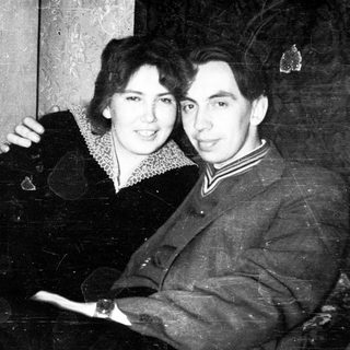 Vintage portrait of a couple standing close together.