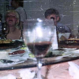 People seated at a table with food and drinks.