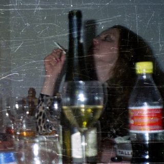 People seated at a table with food and drinks.