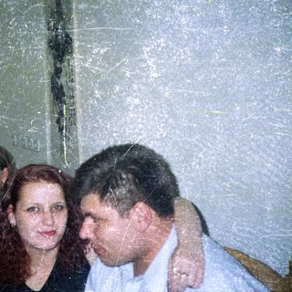 Three people are close together in a slightly blurry photo.