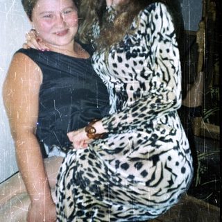 Two young women stand together, posing for a photo.