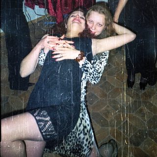 Woman in leopard print dress lies on the floor.