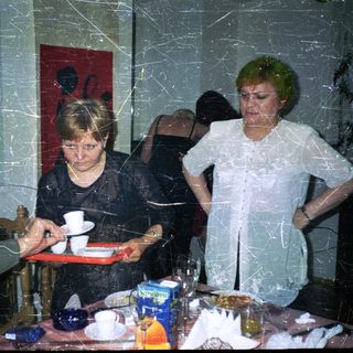 Three people seated at a table in an indoor setting.