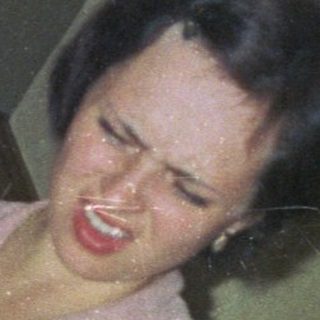 Woman appears to be experiencing a carnival ride.
