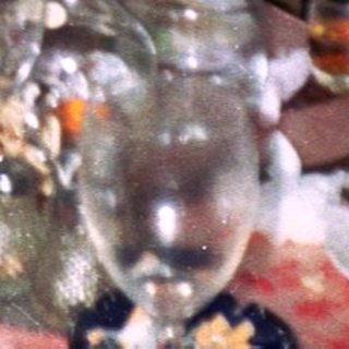 Two women at a table with food and drinks.