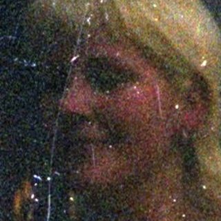 Here's a brief summary of the image: Woman and man seen through a rain-streaked window.
