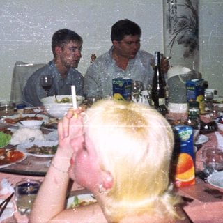Group seated at a table with food and drinks.
