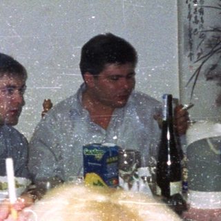 Group seated at a table with food and drinks.
