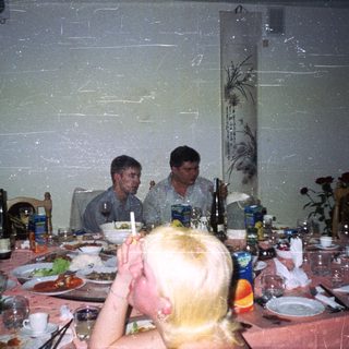 Group seated at a table with food and drinks.