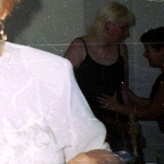 Group of people in a room, one woman in focus.