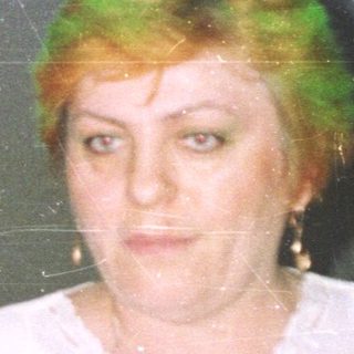 Group of people in a room, one woman in focus.