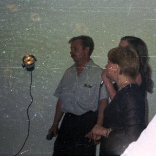 Group of people in a room, one woman in focus.