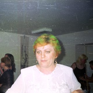 Group of people in a room, one woman in focus.
