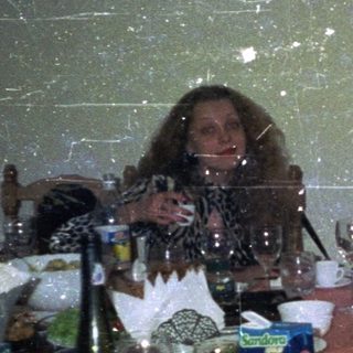 People dine at a table with drinks and food.