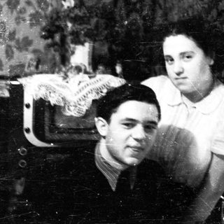 Black and white portrait of a couple in a parlor.