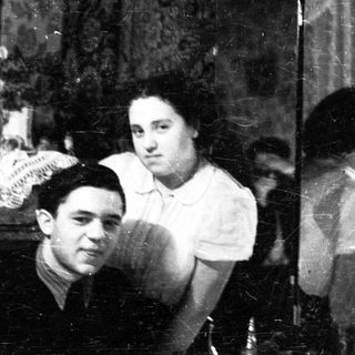 Black and white portrait of a couple in a parlor.