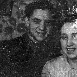 Here's a brief summary of the image: Pair of people in a black and white portrait.