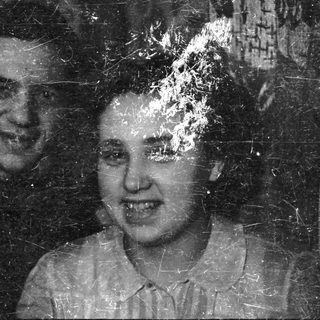 Here's a brief summary of the image: Pair of people in a black and white portrait.