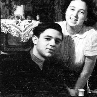 Couple looking in a mirror, vintage photograph.