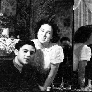 Couple looking in a mirror, vintage photograph.