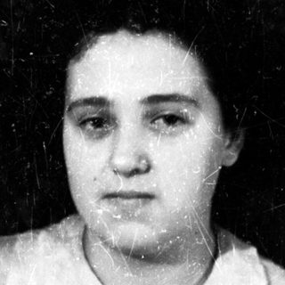 Black and white portrait of a woman in a shirt.