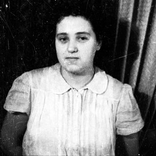 Black and white portrait of a woman in a shirt.