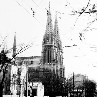 Black and white photo of a church with tall spires.