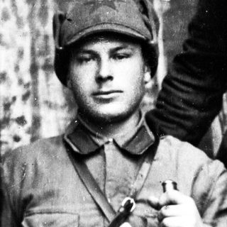 Man in military uniform and cap, black and white photo.