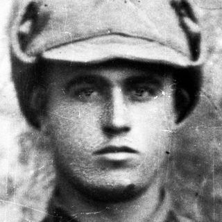 Black and white portrait of a man wearing a military cap.