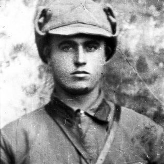 Black and white portrait of a man wearing a military cap.