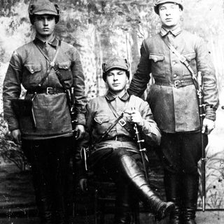 Three men in military uniforms pose for a portrait.