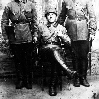 Three men in military uniforms pose for a portrait.