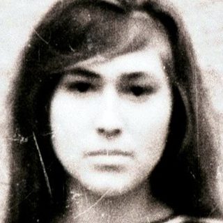 Black and white portrait of a young woman with striped shirt.