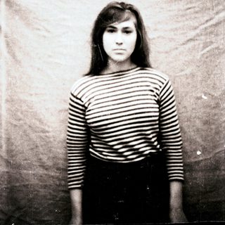 Black and white portrait of a young woman with striped shirt.
