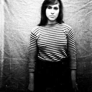 Black and white portrait of a young woman, striped shirt.