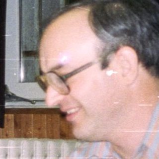 People seated at a table, celebrating with food and drinks.