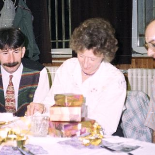 People seated at a table, celebrating with food and drinks.